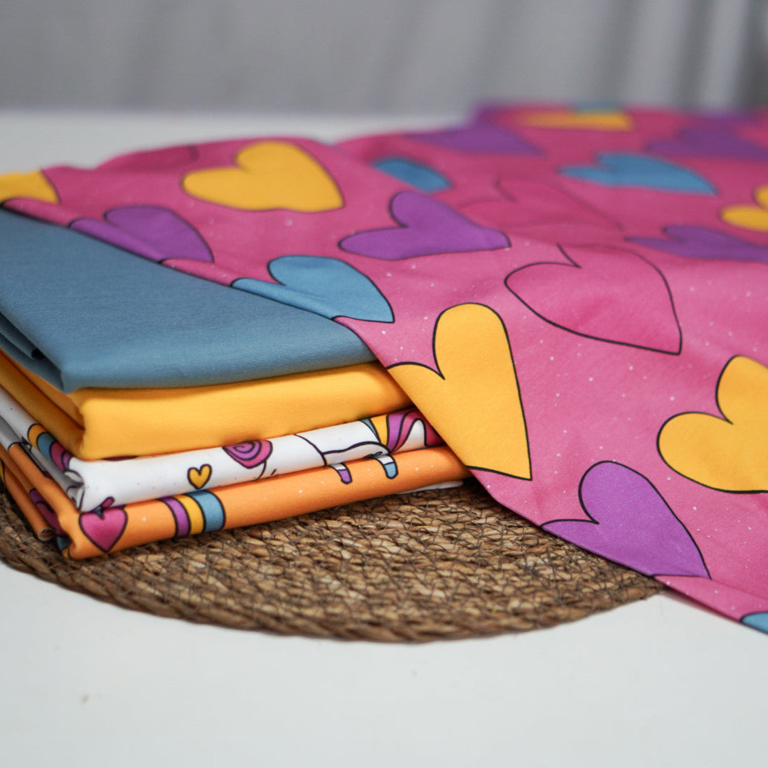 Kinderstoff Meterware bunte Herzchen auf rosa von Katzengold Design mit Kombis